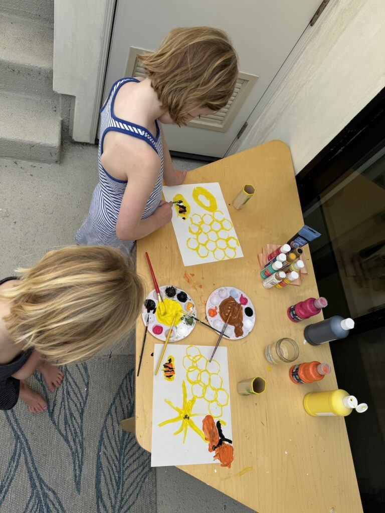 Painting a beehive with toilet paper rolls. 